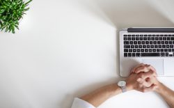 man sitting by laptop