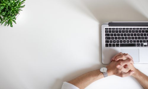 man sitting by laptop