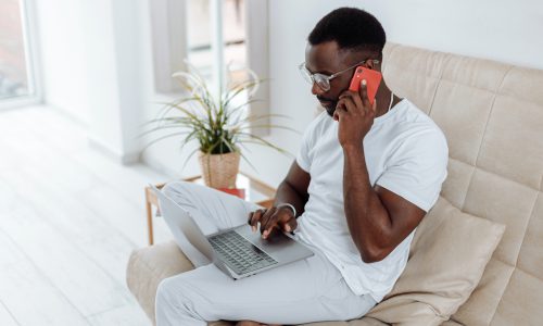 man on his phone and laptop